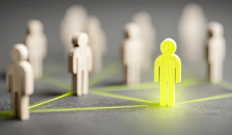 Image of wooden humans connected by yellow lines