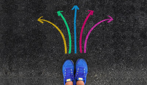 Image of a pair of shoes with colourful arrows around it