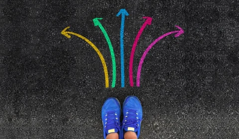Image of a pair of shoes with colourful arrows around it