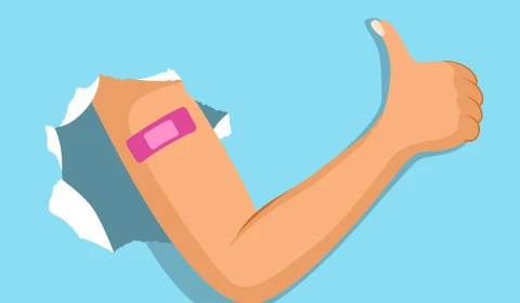 Arm breaks through paper blue background shows pink adhesive band making thumb up gesture.