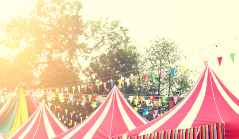 An image of red circus tents on a sunny day