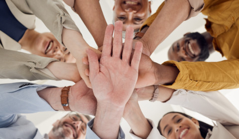 Image of a group of people putting their hand together