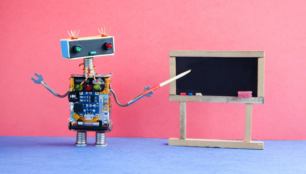 Robot pointing to a blackboard