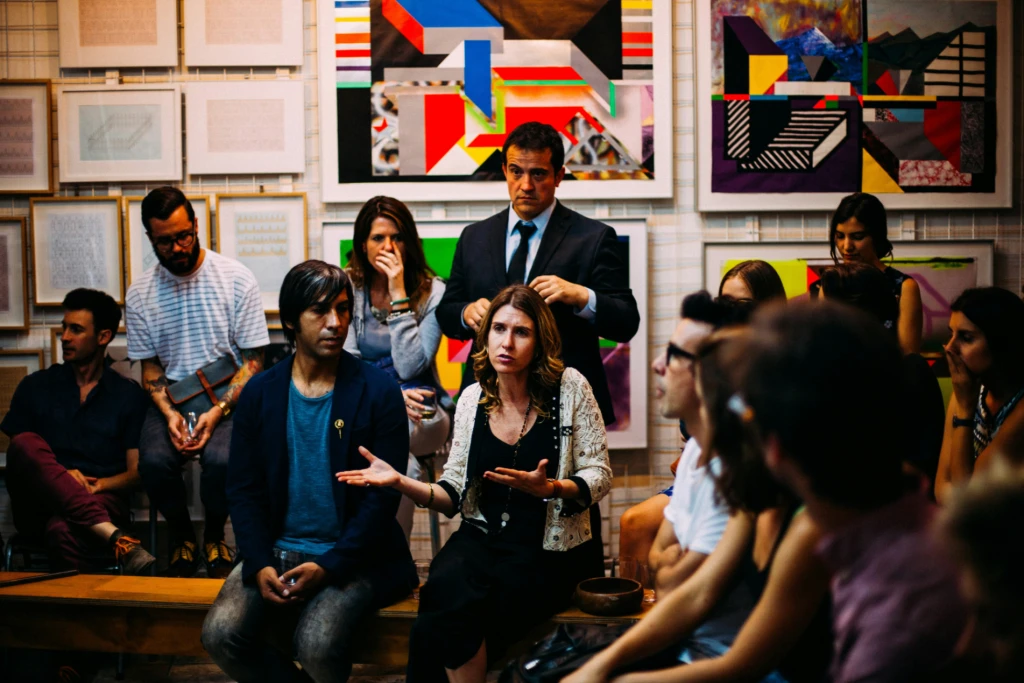 A group of people gather in debate and conversation.