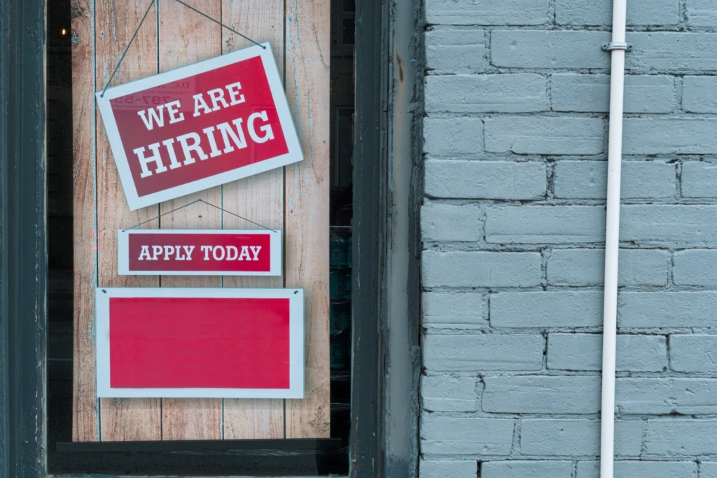 A recruitment poster stating 'we are hiring'.