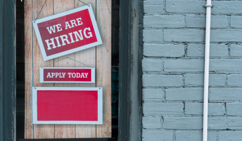 A recruitment poster stating 'we are hiring'.