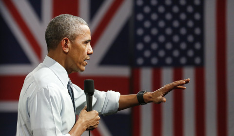An image of Obama presenting at a Town Hall in front of a British and American Flag from the US Embassy London.