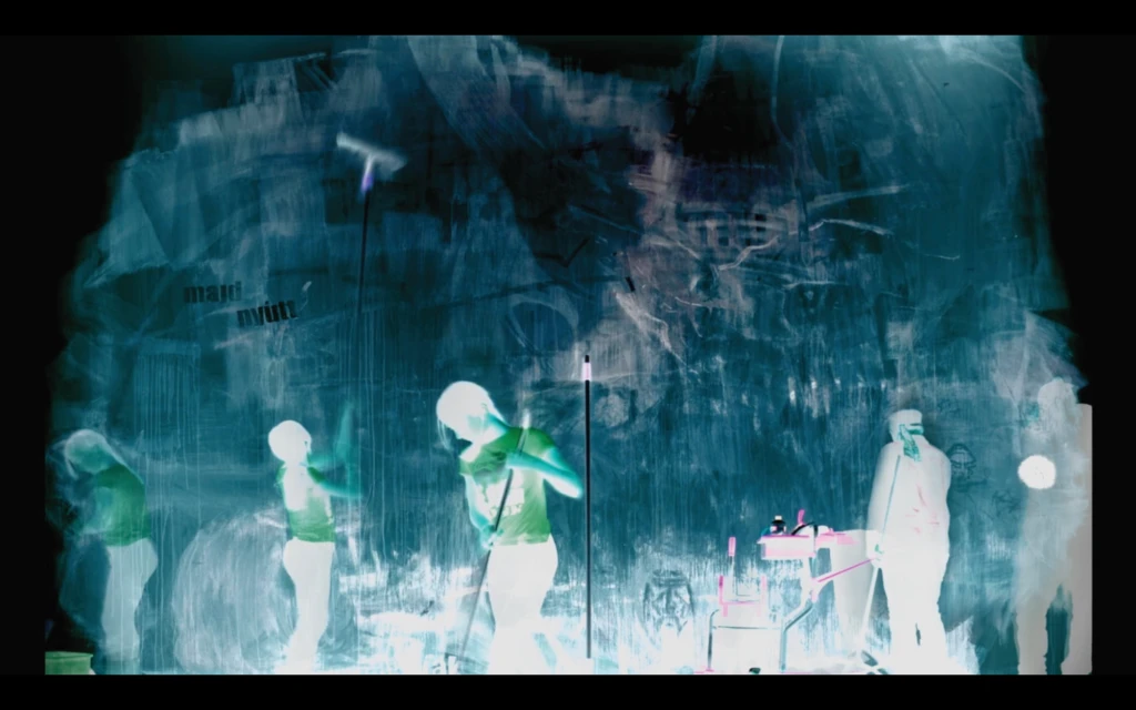 Surreal negative-like image showing people cleaning against a textured blue background.