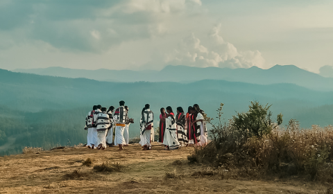 Group of traditionally dressed people on hillside