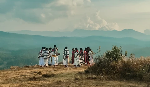 Group of traditionally dressed people on hillside